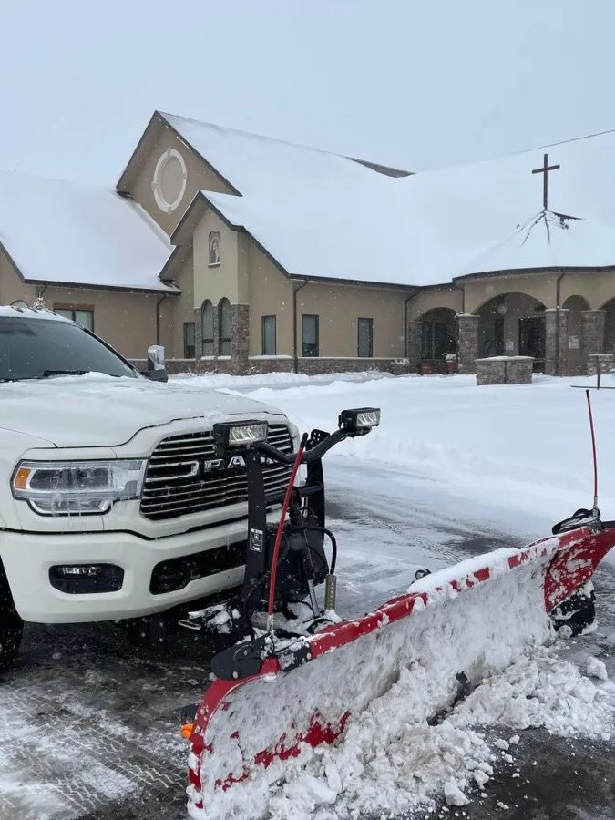 Curascapes plow truck clearing a commercial lot